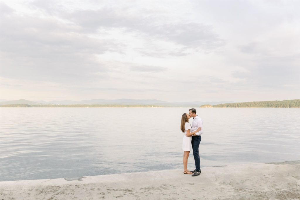 Couple Kissing On Dock By Lake Champlain