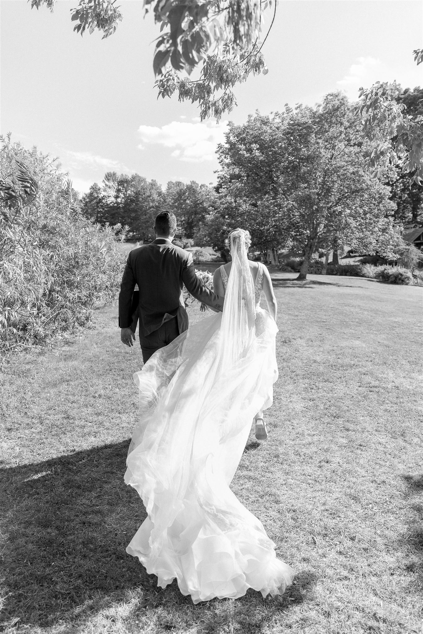 Julia And Drew Walking Away From Their Ceremony At Their Inn At Round Barn Farm Wedding